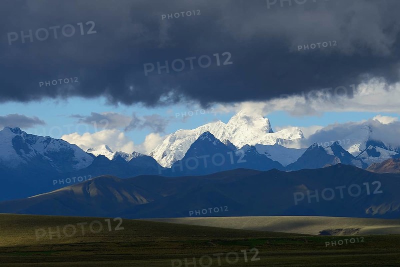 Mountain range of the Cordillera Blanca under dark clouds