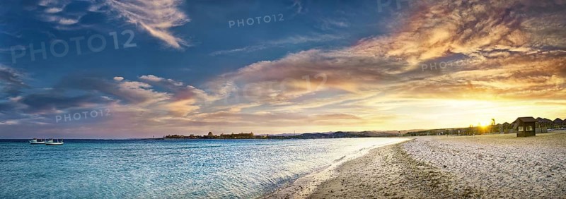 Sandy beach beach and coral reef Abu-Dabbab at sunset