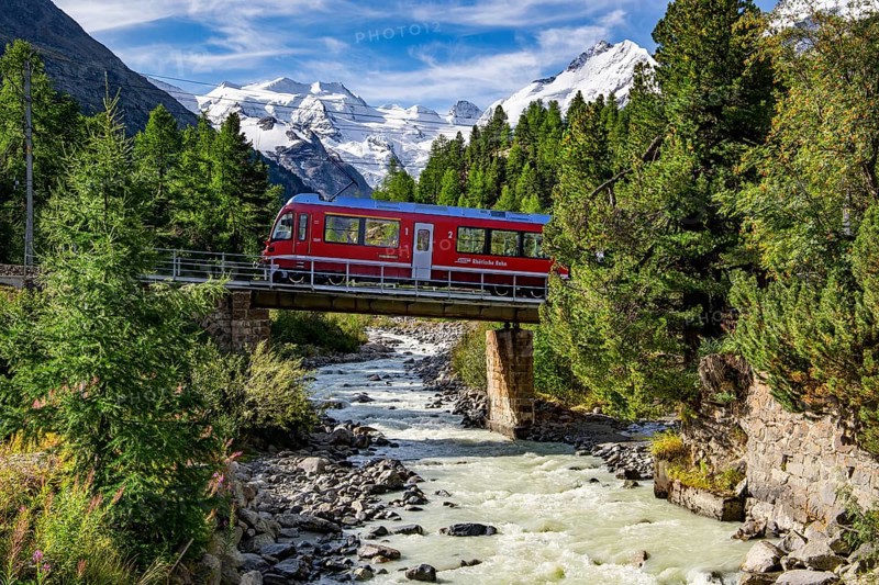 Train of the Bernina line in the Morteratsch valley with Bellavista and Piz Bernina