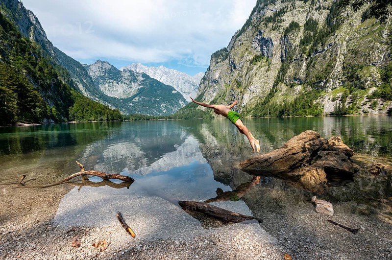 Young man jumps into lake