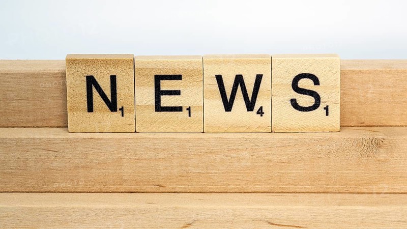 Letter blocks on a wooden bar form the word News
