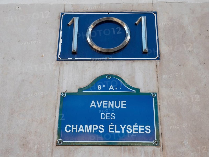 A plaque with the number 101 and a plaque with the name of the Avenue des Champs-Elysees