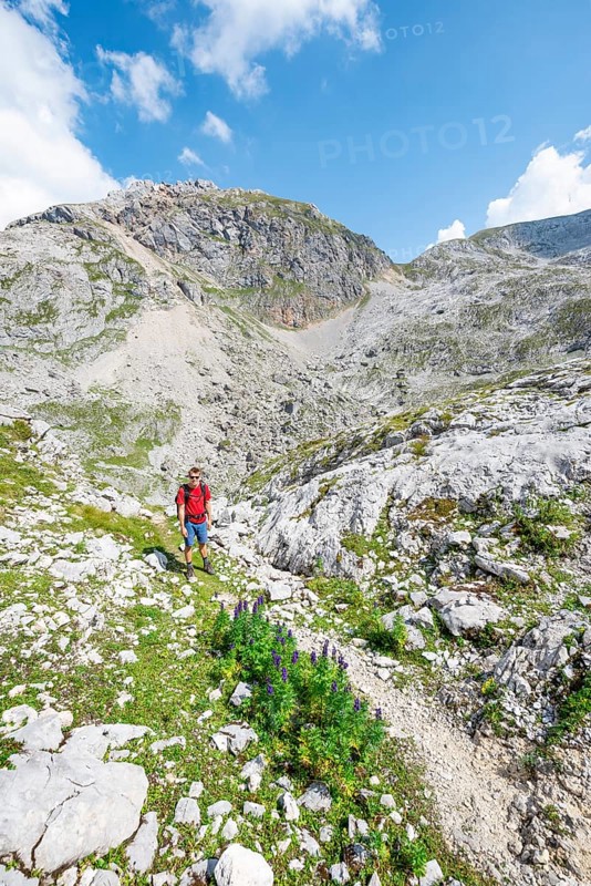 Hikers in a landscape of washed out karst rocks