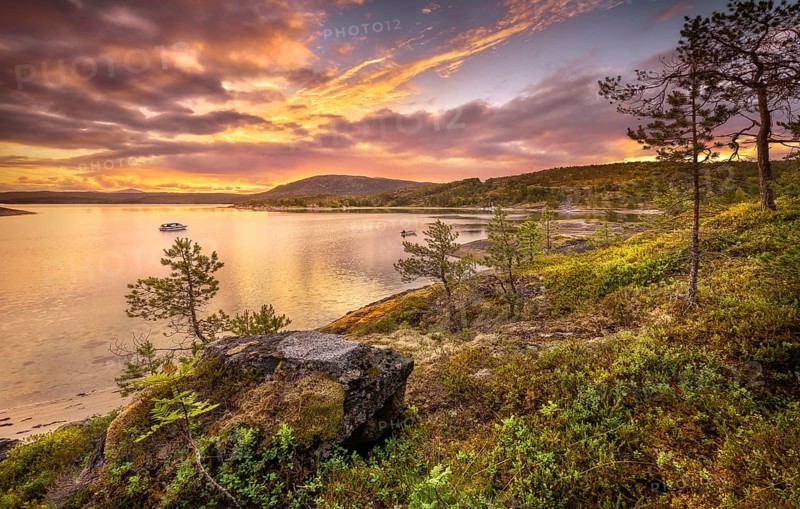 Midnight sun in midsummer by the fjord
