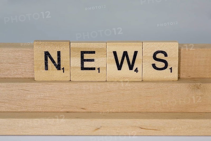 Letter blocks on a wooden bar form the word News