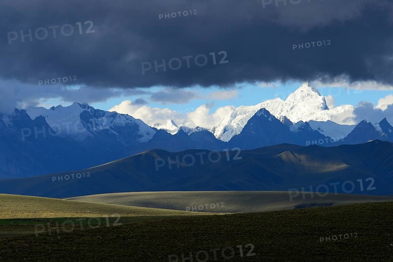 Mountain range of the Cordillera Blanca under dark clouds