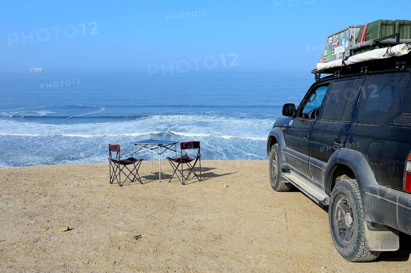Camping furniture and off-road vehicles at Supay Beach