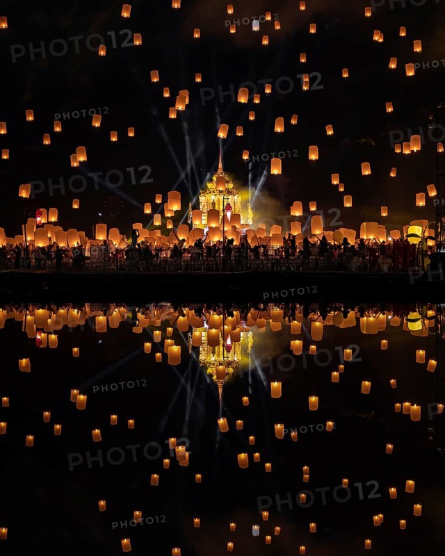 Yi Peng Festival with rising lanterns and a reflection in the lake