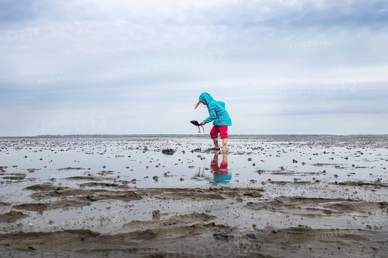 Child playing in the mudflats