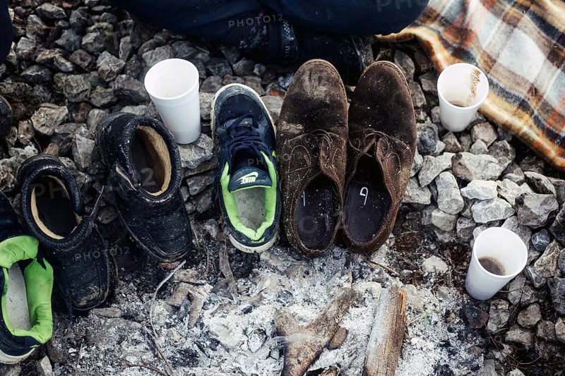 Several pairs of shoes in front of a tent