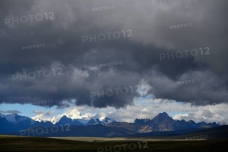 Mountain range of the Cordillera Blanca under dark clouds