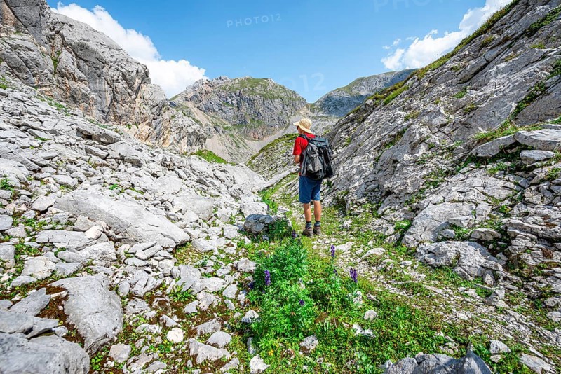 Hikers in a landscape of washed out karst rocks