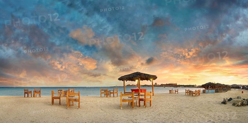 Sandy beach beach with bar at the coral reef Abu-Dabbab at sunset