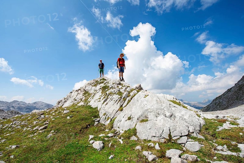 Two hikers standing on a rock