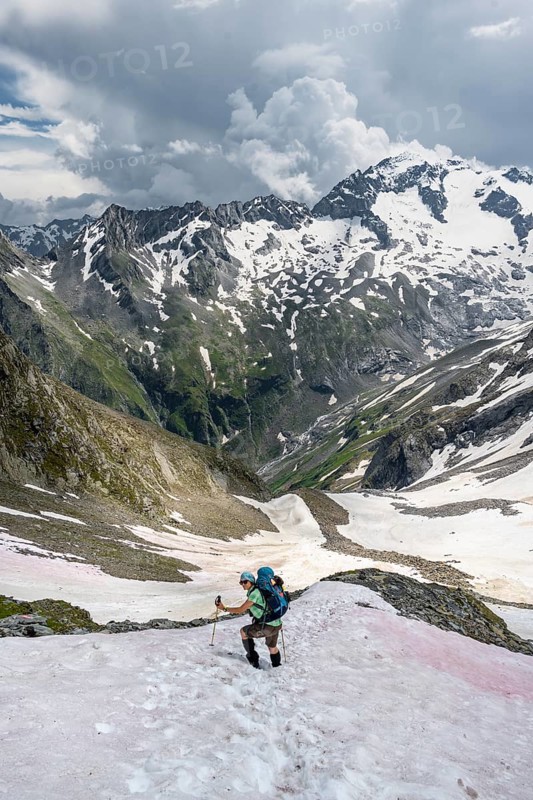 Hiker crosses snowfield
