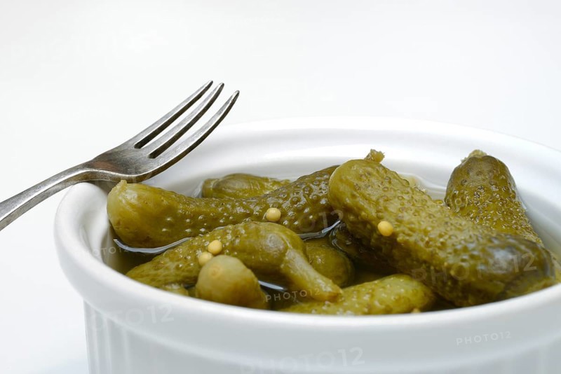 Cornichons in bowl with fork