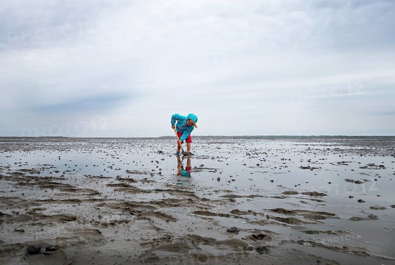 Child playing in the mudflats