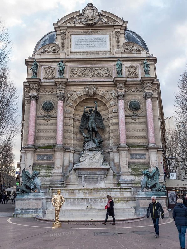 Bronze statue of the fountain La Fontaine Saint Michel at Place Saint-Michel