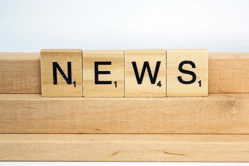 Letter blocks on a wooden bar form the word News