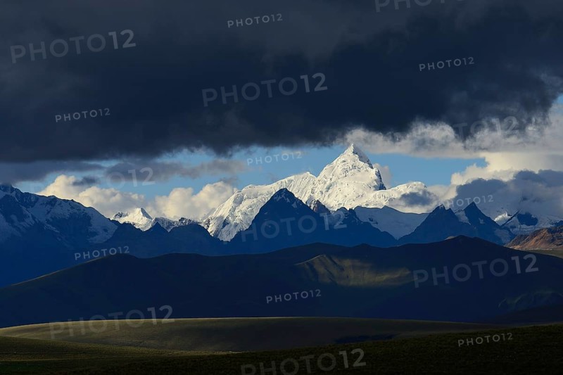 Mountain range of the Cordillera Blanca under dark clouds