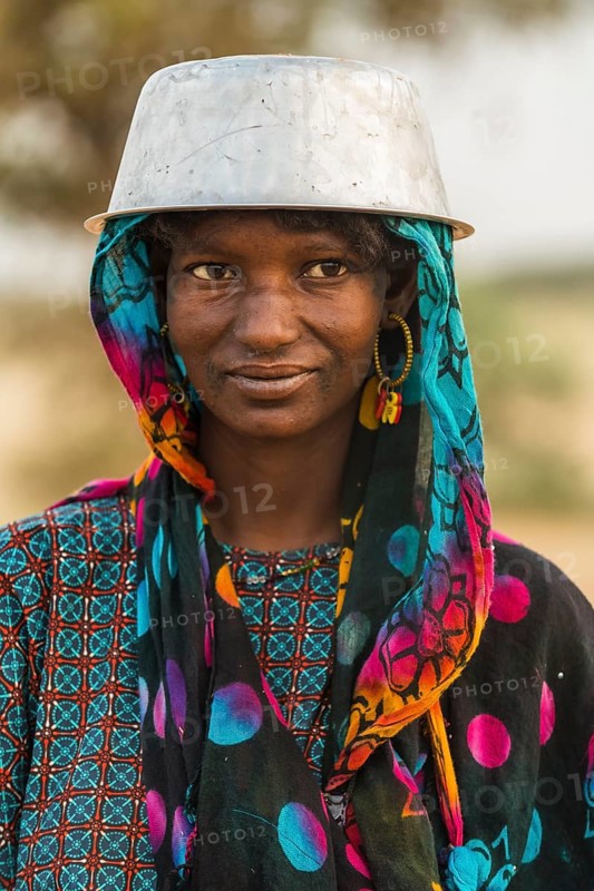 Young girl with a a water pot on her head