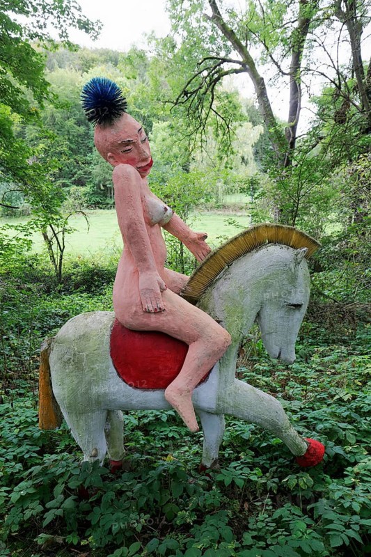 Naked Amazon riding a horse