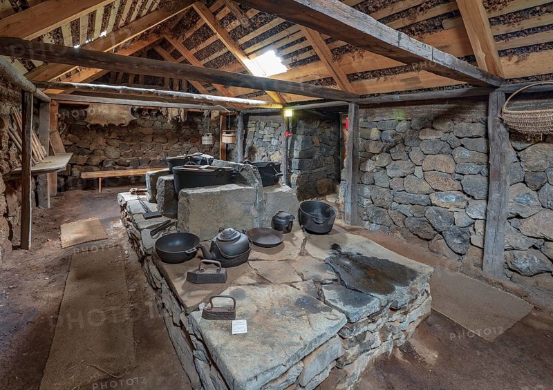Interior view of pots and pans on an old fireplace in the back Hides on peat farm