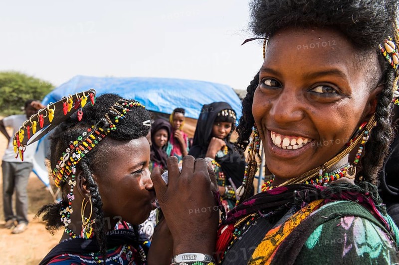 Two girls sharing a waterbag