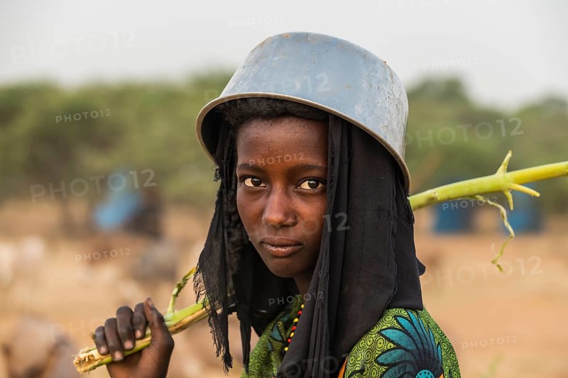 Young girl with a a water pot on her head
