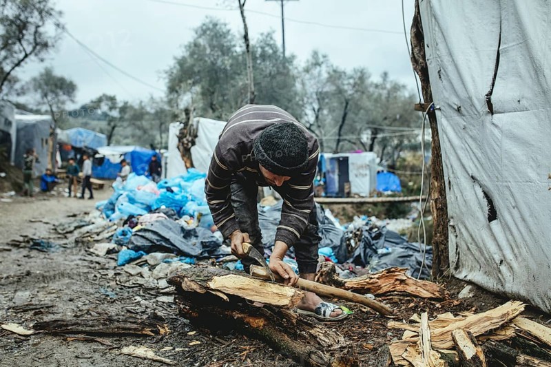 Fugitive in camp chopping firewood