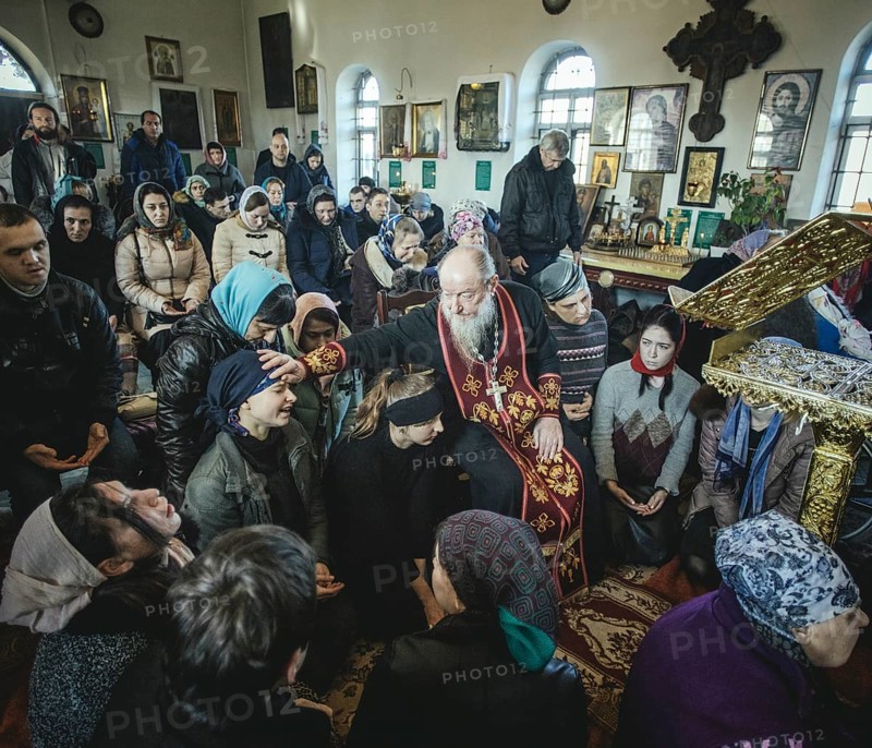 Father Sergei during an exorcism in his church in Ochamchira