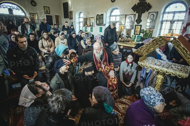 Father Sergei during an exorcism in his church in Ochamchira