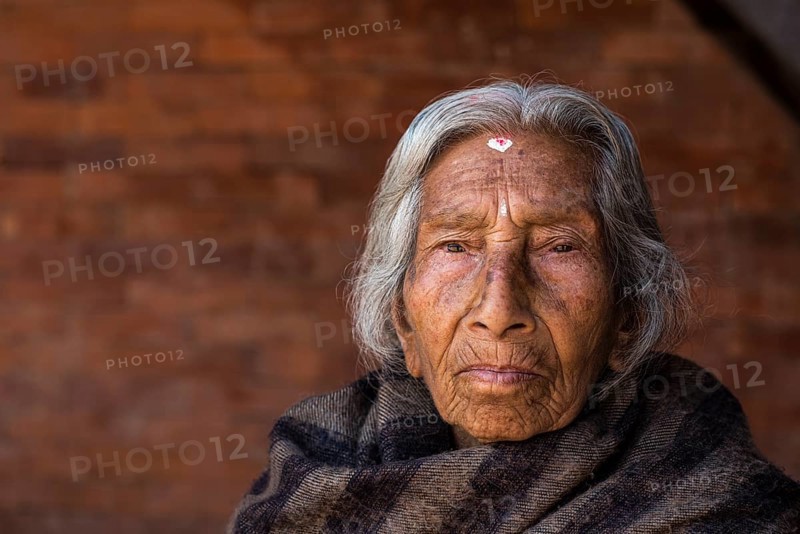 Portrait of an old Hindu woman wrapped in a blanket