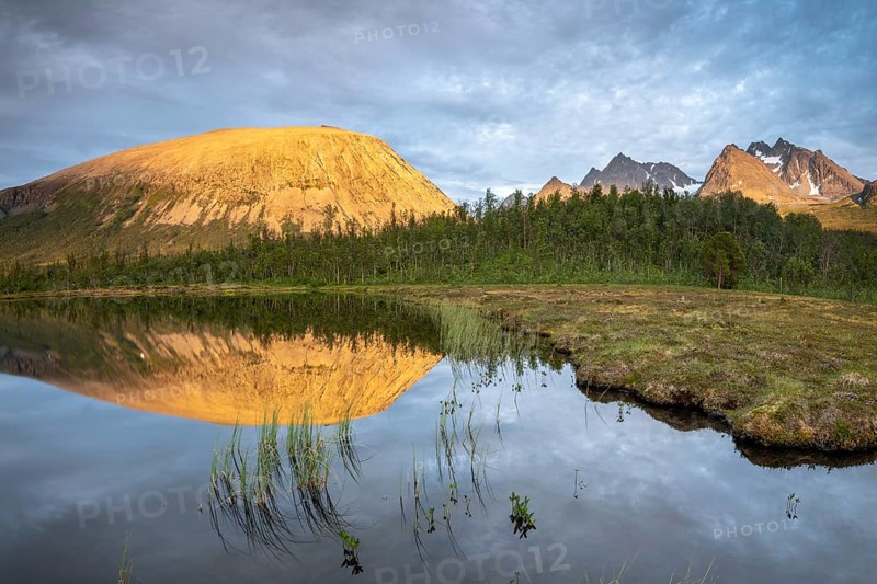 Mountains of the Lyngen Alps are reflected in the lake