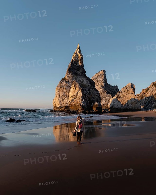 Marked rocks at Praia da Ursa beach with person