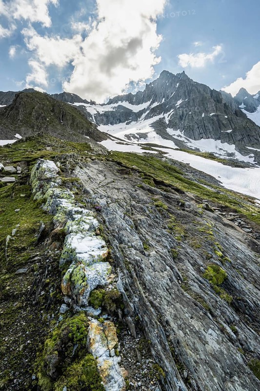 Hikers in front of snow-covered mountains