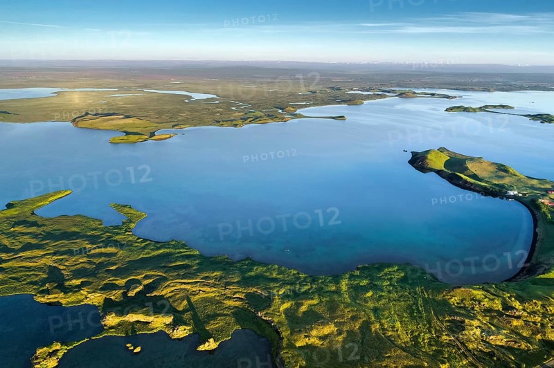 Aerial view of coast with green pseudo-craters