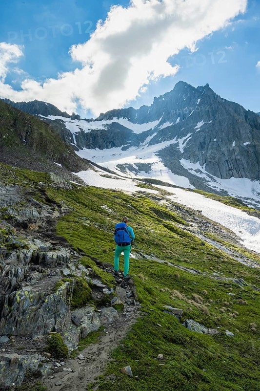 Hikers in front of snow-covered mountains