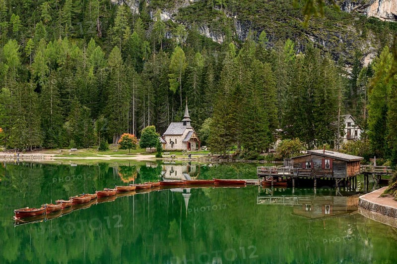 Chapel and boathouse with rowing boats at the Lake Prags Lake