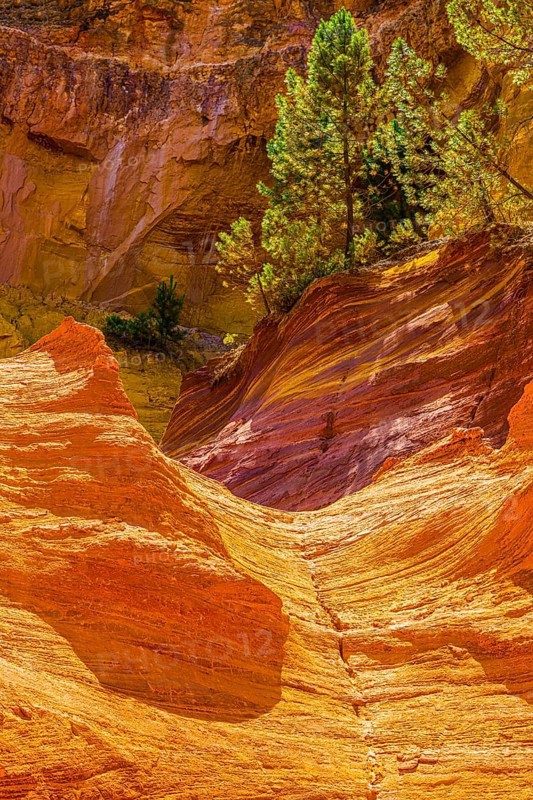 Yellow and red glowing rock walls in the natural park of the ochre rocks near Roussillon