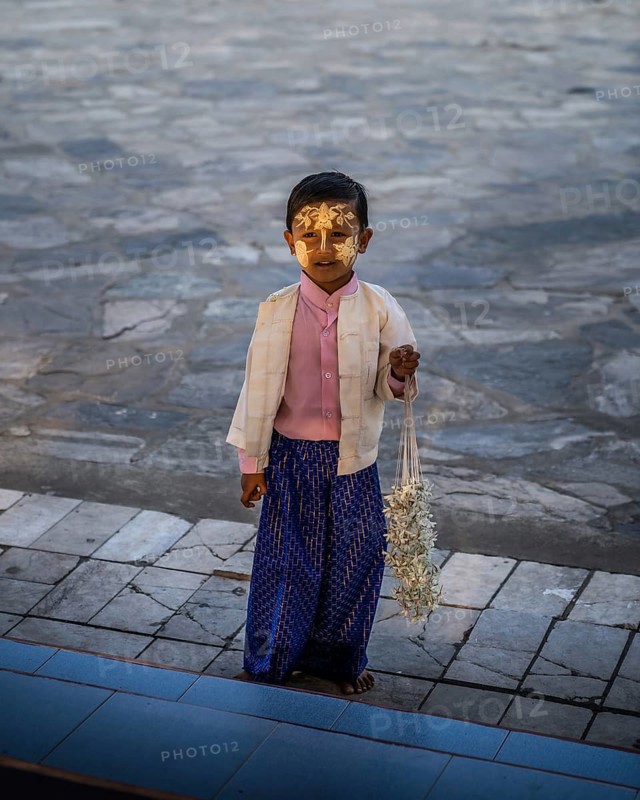 Small boy with yellow face painting