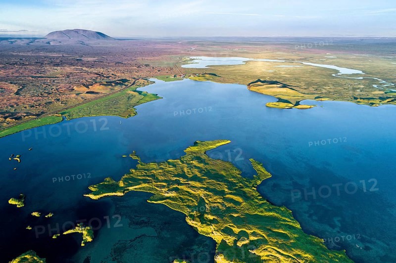 Aerial view of coast with green pseudo-craters