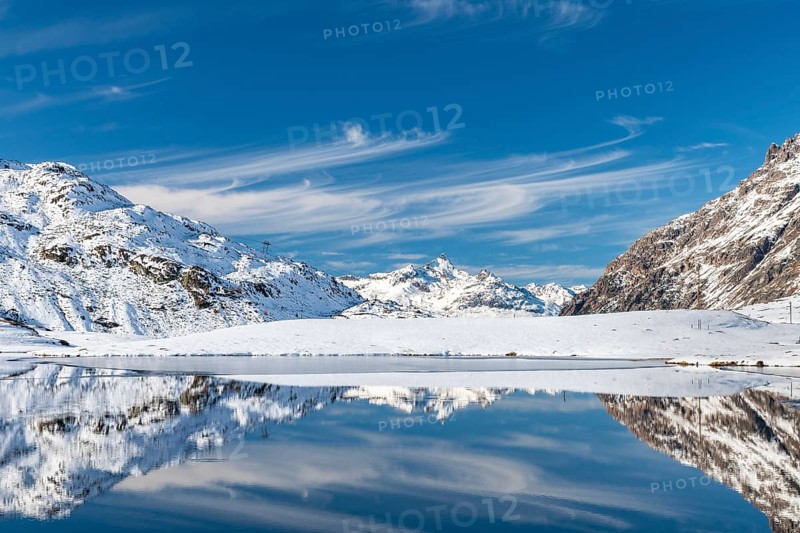 Snowy landscape reflected in Lago Bianco