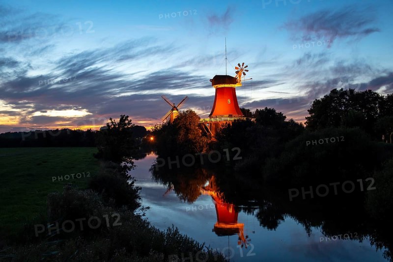 Illuminated Greetsiel twin mills at sunset