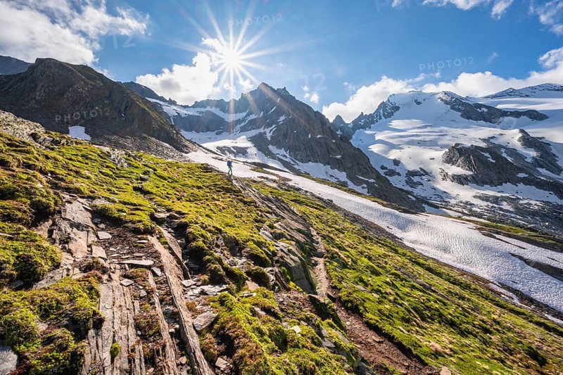 Hikers in front of snow-covered mountains