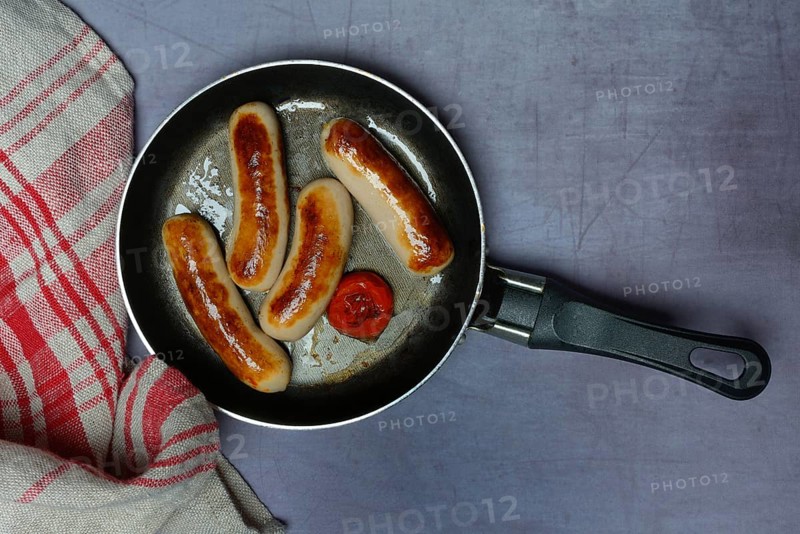 Chipolata sausages in pan