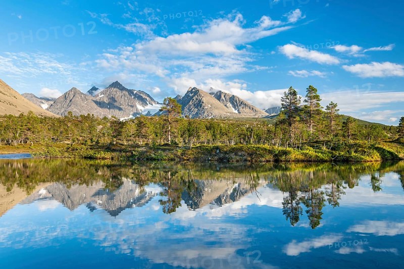 Mountains of the Lyngen Alps are reflected in the lake