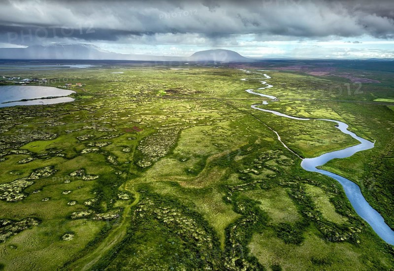 Wide green plain with river