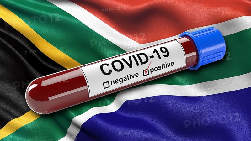Flag of South Africa waving in the wind with a positive Covid-19 blood test tube. 3D illustration