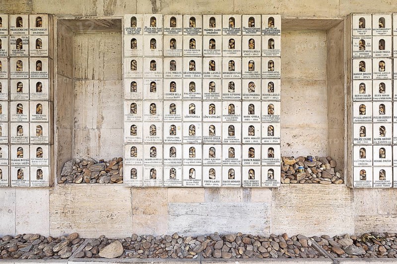 Wall with memorial plaques and deposited stones in memory of the murdered Jews and the Holocaust